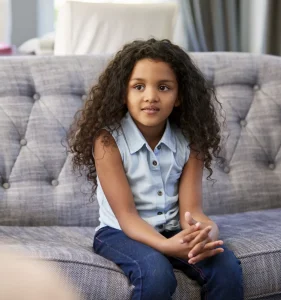 Image of a young girl sitting in a therapy session