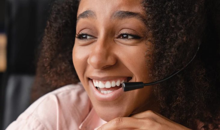 Image of a young woman wearing a computer headset