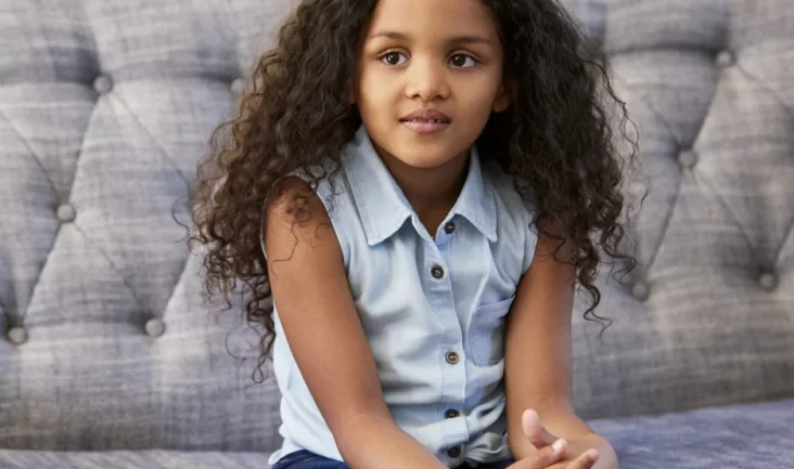 Image of a young girl sitting in a therapy session